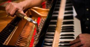man-retuning-piano