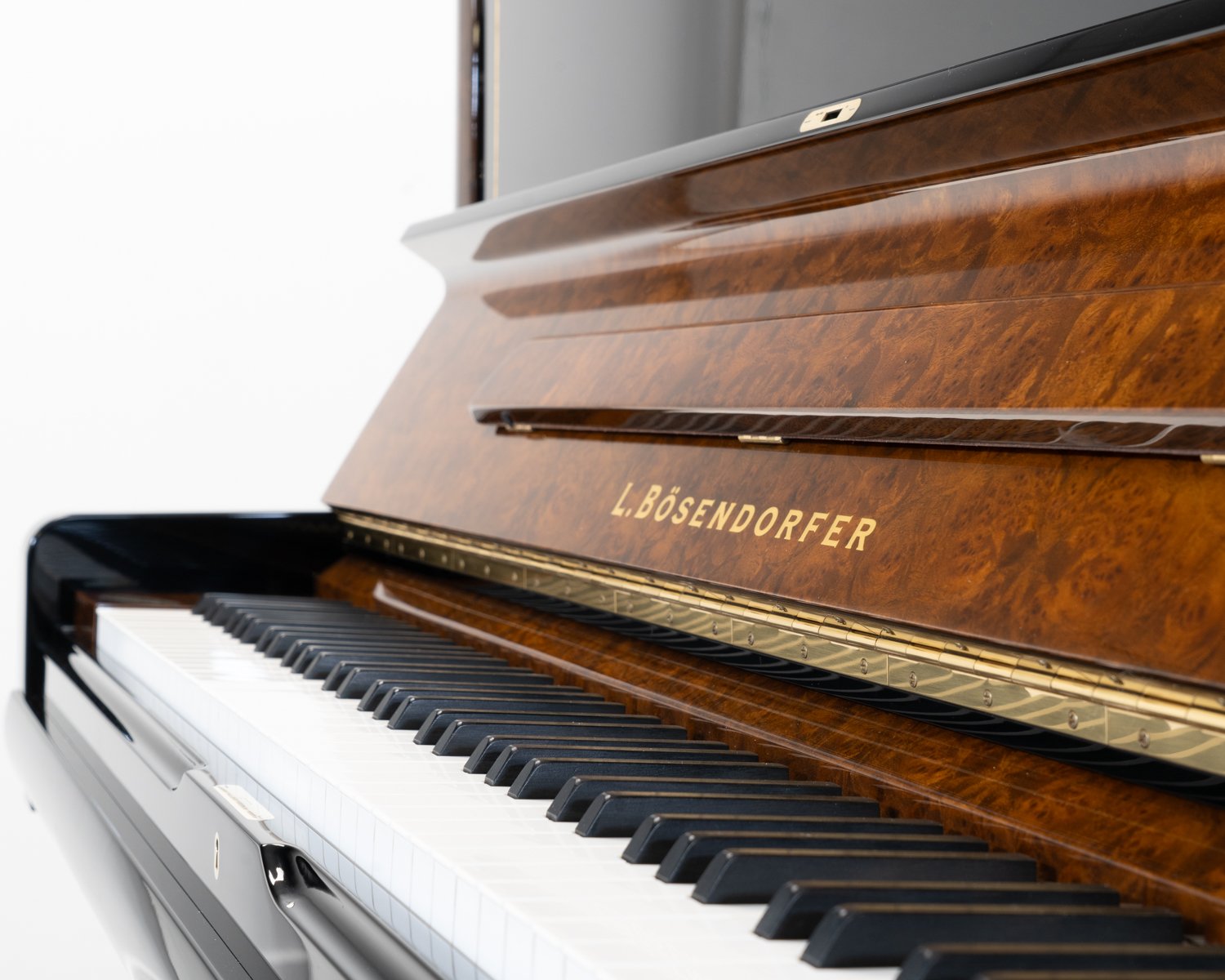 Bosendorfer 130 upright piano in polished black with burr walnut