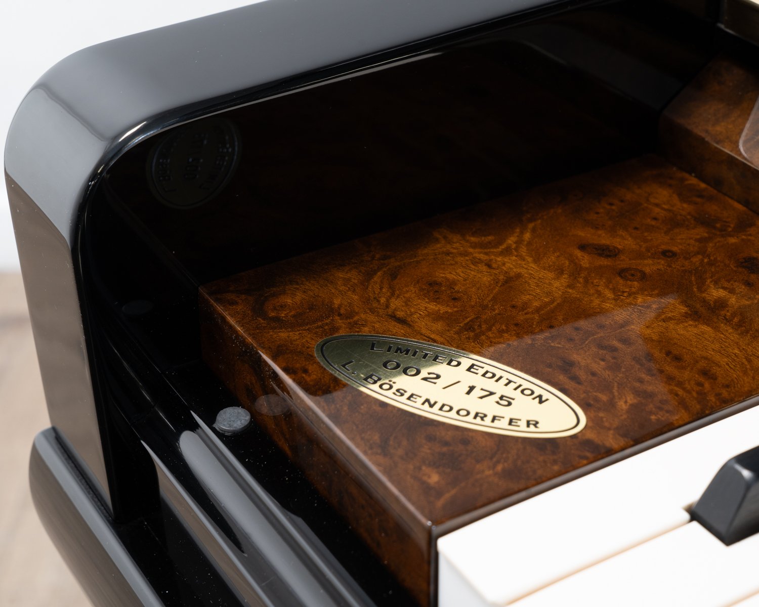 Bosendorfer 130 upright piano in polished black with burr walnut